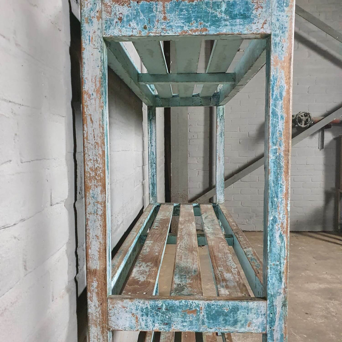 Vintage storage rack of old wood with blue patina