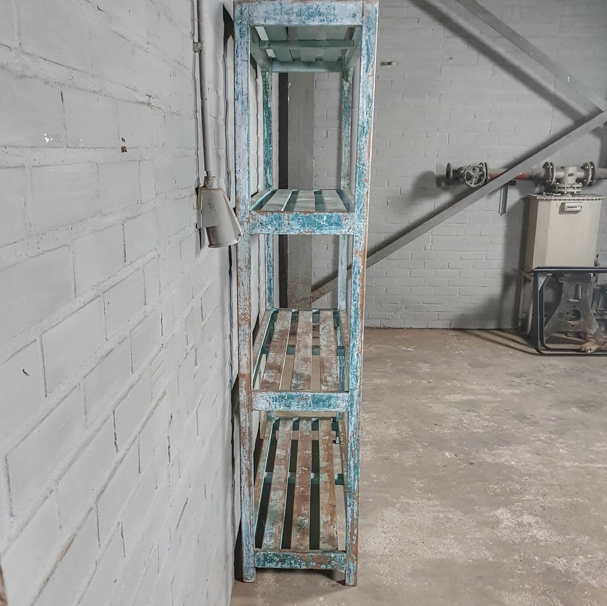 Vintage storage rack of old wood with blue patina