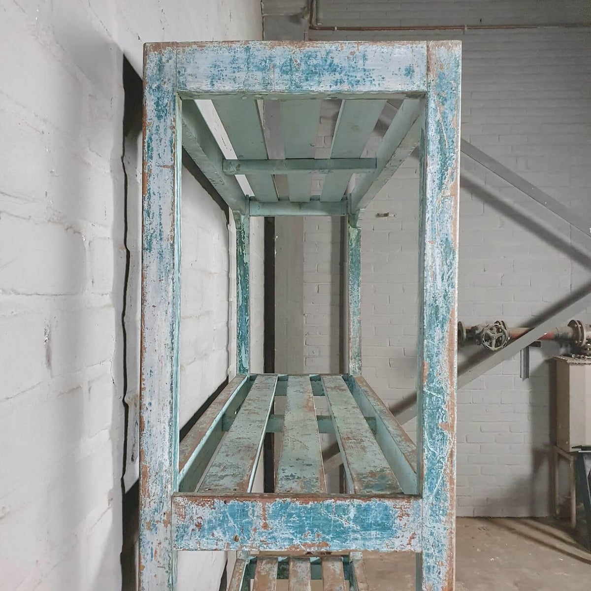 Vintage storage rack of old wood with blue patina